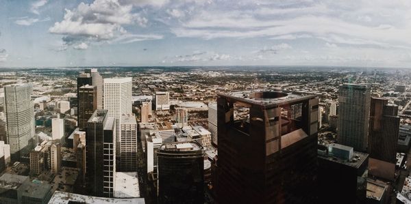 High angle view of cityscape against cloudy sky