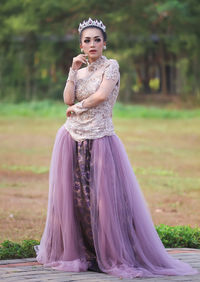 Portrait of bride standing on footpath