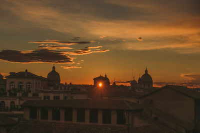 Buildings in city during sunset