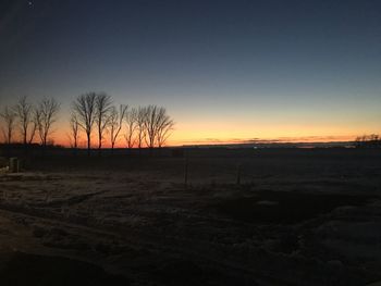 Silhouette landscape against sky during sunset