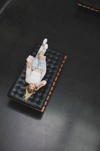 High angle portrait of woman lying on mattress