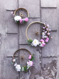 Flowers in bicycles wheel on the wall at the street of przemysl at spring