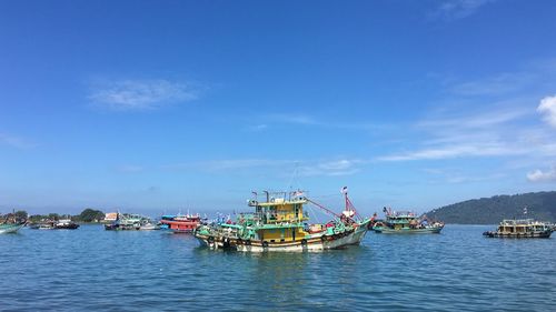 Fishing boat in sea against sky