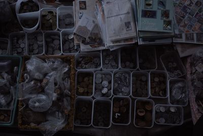 High angle view of coins in containers