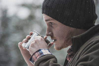 Portrait of young man smoking cigarette