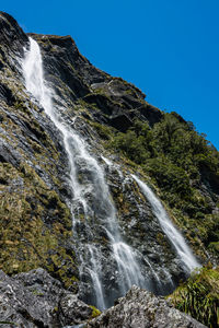 Low angle view of earland falls waterfall against clear sky