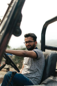 Portrait of young man sitting outdoors