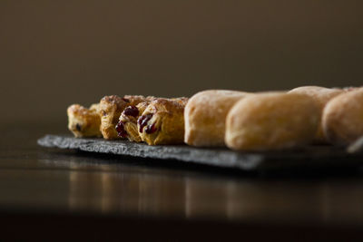 Close-up of cake on table against black background