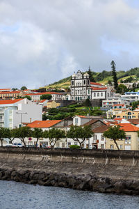  buildings by the sea against the city sky