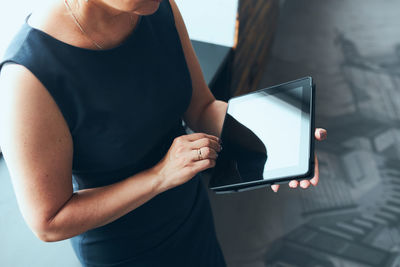 Midsection of woman using mobile phone