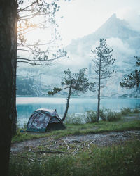 Scenic view of lake by mountains against sky