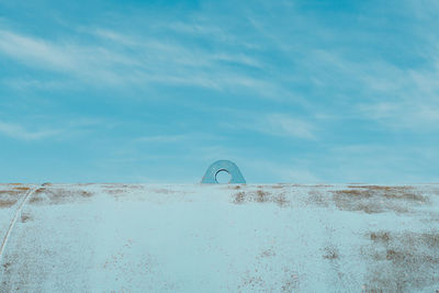 Metallic pipe against blue sky