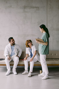 Happy multiracial medical colleagues discussing at hospital