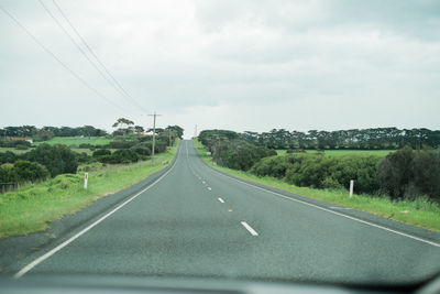 Road passing through landscape against sky