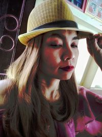Portrait of young woman in hat
