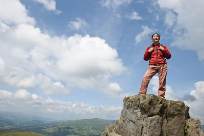 Woman standing on mountain top in south wales / uk