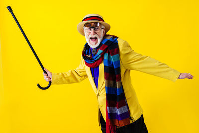 Man shouting while holding walking cane