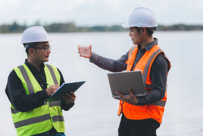Rear view of man using mobile phone