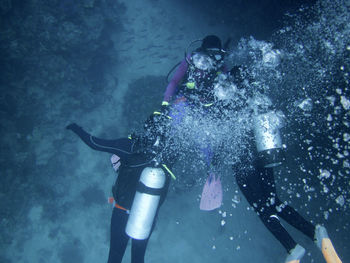 People scuba diving undersea