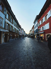 Street amidst buildings against sky in city