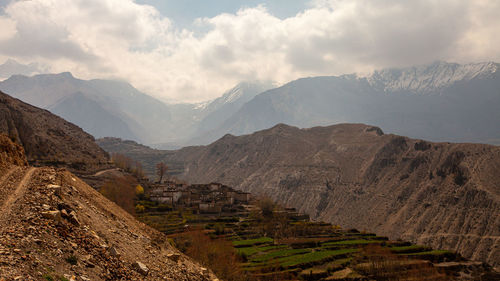 Scenic view of mountains against cloudy sky