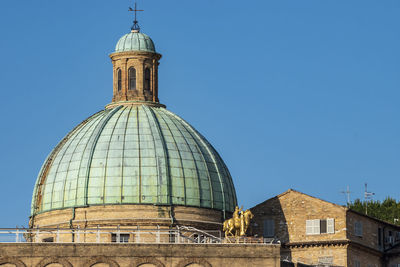 Low angle view of building against clear blue sky