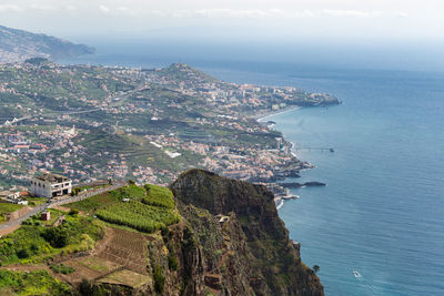 High angle view of townscape by sea against sky