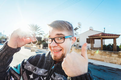 Portrait of smiling young man against sky