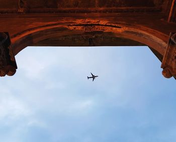 Low angle view of airplane flying in sky