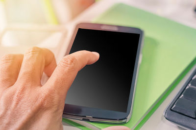 Close-up of hand holding mobile phone