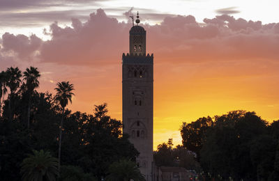 Tower of building against sky during sunset