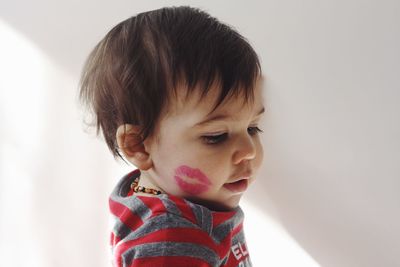 Portrait of toddler with lipstick kiss