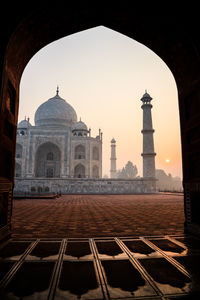 Taj mahal seen through arch against sky