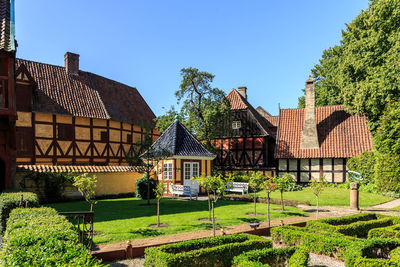 Houses and trees against blue sky