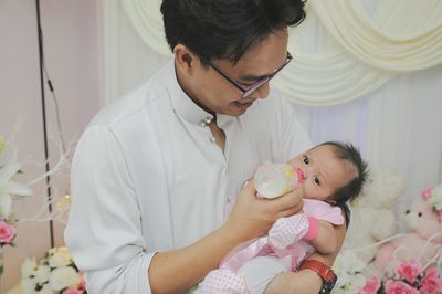 Close-up of father feeding daughter