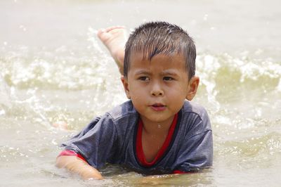 Cute boy lying at beach