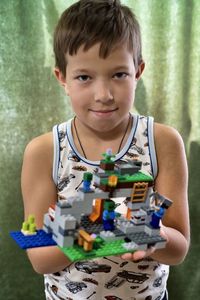 Portrait of boy holding toy