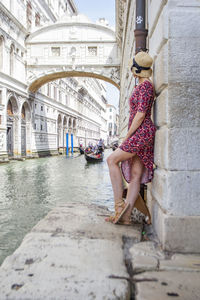 Full length of young woman standing in city