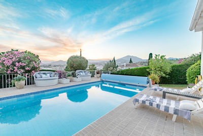 A garden image full with deck chairs and a swimming pool along the costa del sol