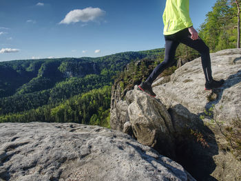 Man runner body and shadow on sandstone rock. running man body within mountain trail