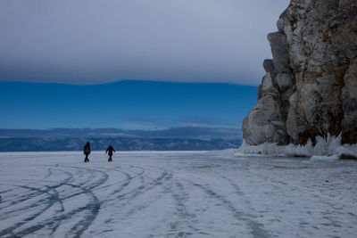 People on frozen lake during winter