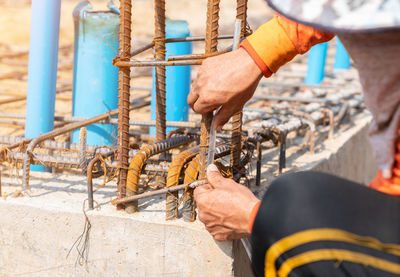 Cropped hand of man working at construction site