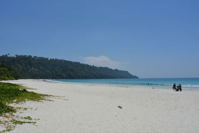 Scenic view of beach against blue sky