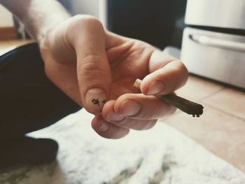 Close-up of woman hand holding cigarette