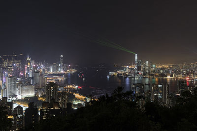 High angle view of illuminated buildings against sky at night