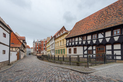 Street amidst buildings against sky