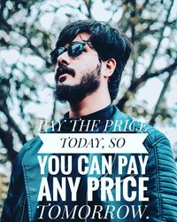 Portrait of young man against tree