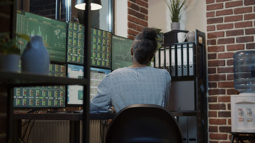 Rear view of businesswoman sitting at office