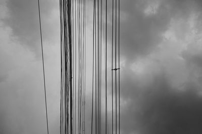 Low angle view of cables against sky