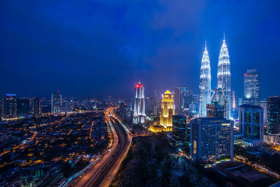 Aerial view of city lit up at night